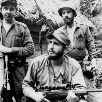 FILE - In this March 14, 1957 file photo, Fidel Castro, the young anti-Batista guerrilla leader, center, is seen with his brother Raul Castro, left, and Camilo Cienfuegos, right, while operating in the Mountains of Eastern Cuba. Cuban President Raul Castro has announced the death of his brother Fidel Castro at age 90 on Cuban state media on Friday, Nov. 25, 2016. (AP Photo/Andrew St. George, File)