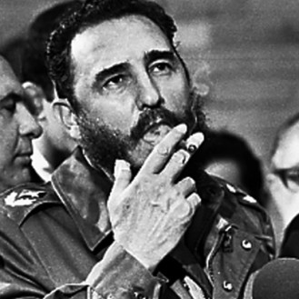 Fidel Castro smokes a cigar during interviews with the press in Havana during a visit of U.S. Senator Charles McGovern in this file photo from May 1975. Picture taken May 1975 REUTERS/Prensa Latina (CUBA) - RTR1HRQX
